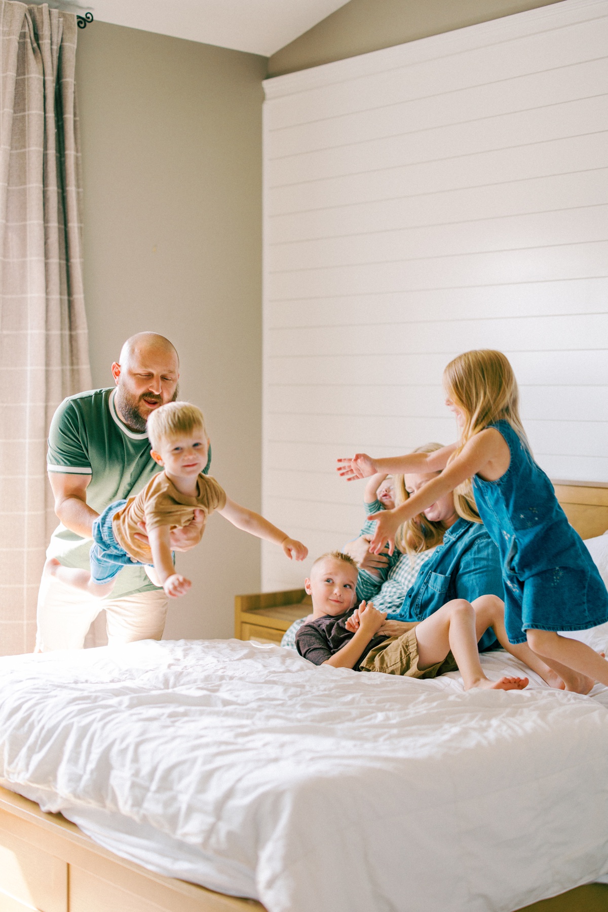 family cuddled up in bed together